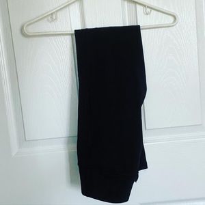 Black leggings with a zipper at the bottom of the leg